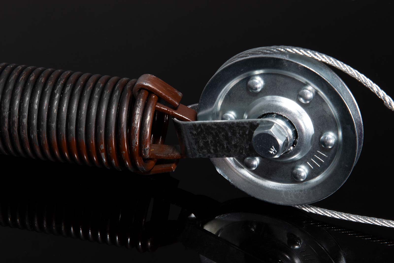 Extension spring with pulley fork and cable on garage door