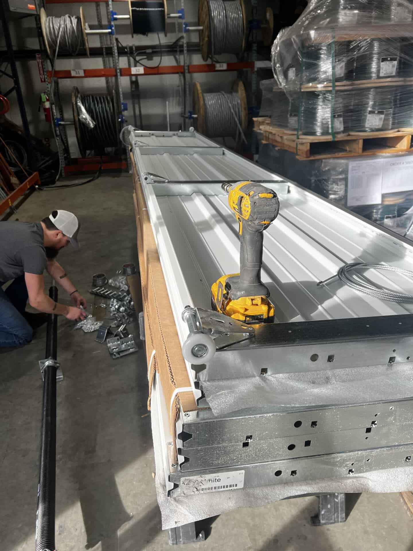 Commercial sectional door panel and opener service inside a shop