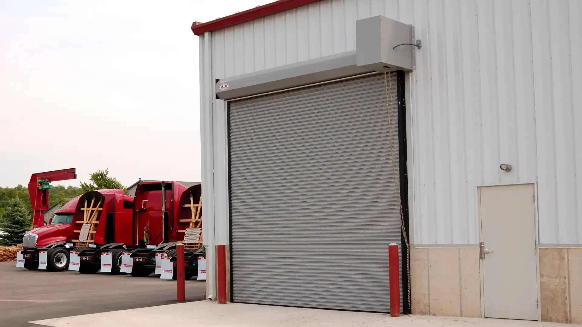 Commercial rolling steel service door on a brick building