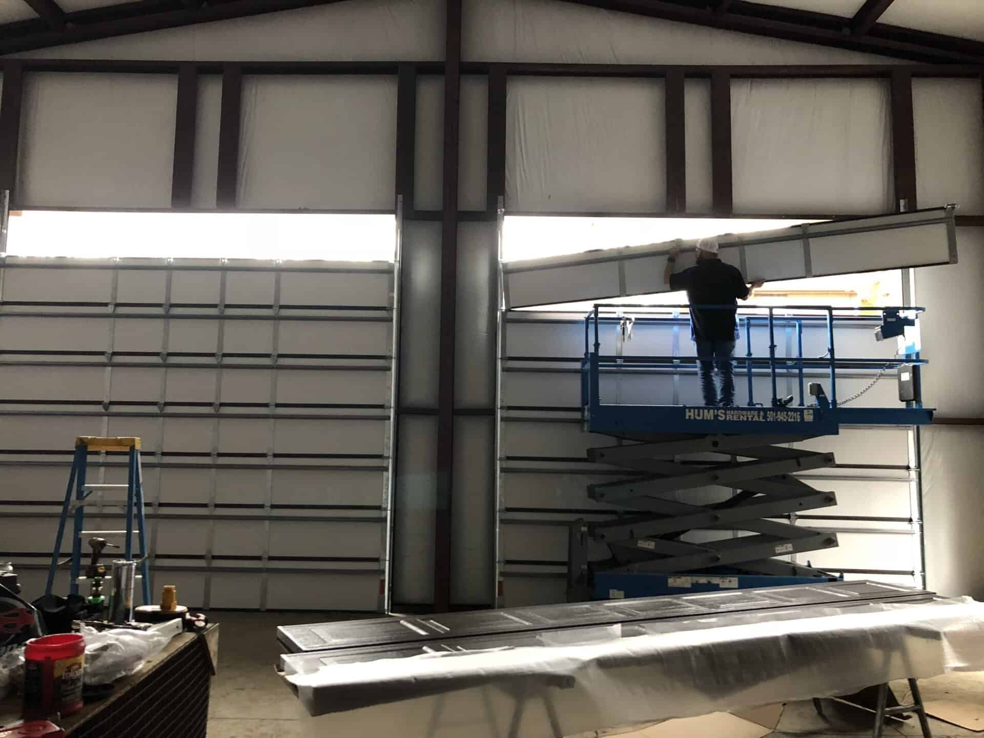 Direct Service technician installing a commercial garage door
