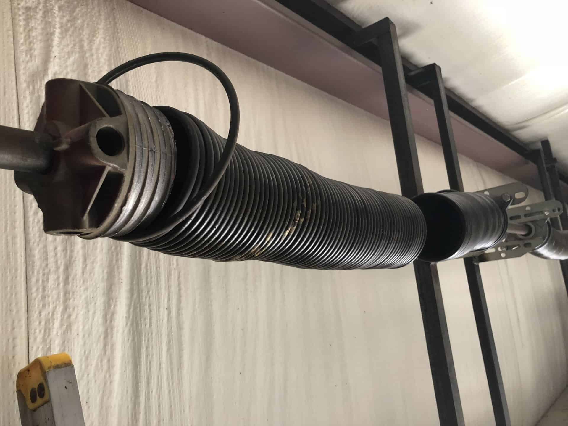 Commercial torsion spring replacement on a sectional door shaft in Central Arkansas