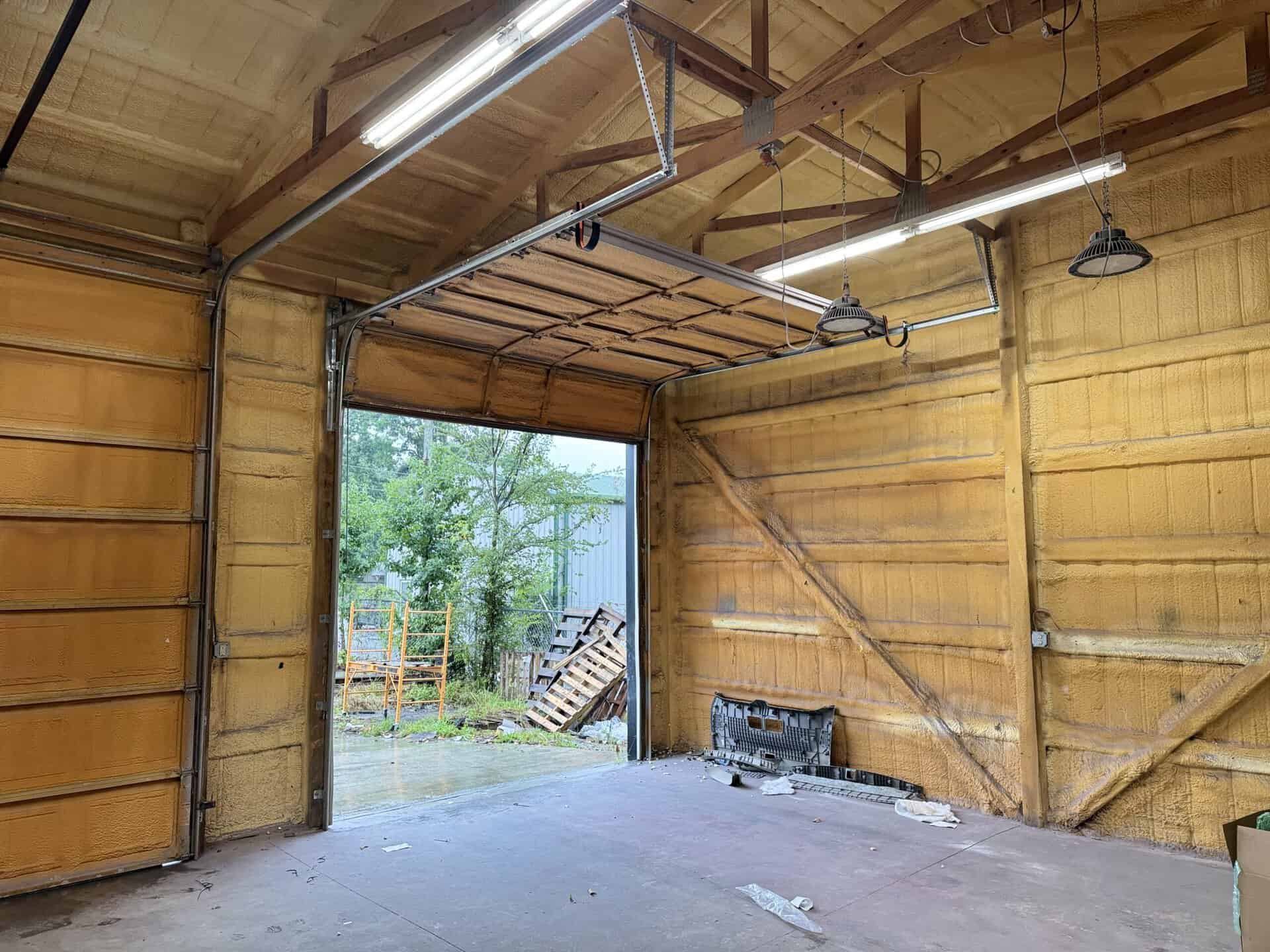 High-lift commercial garage door track and cabling on a steel building