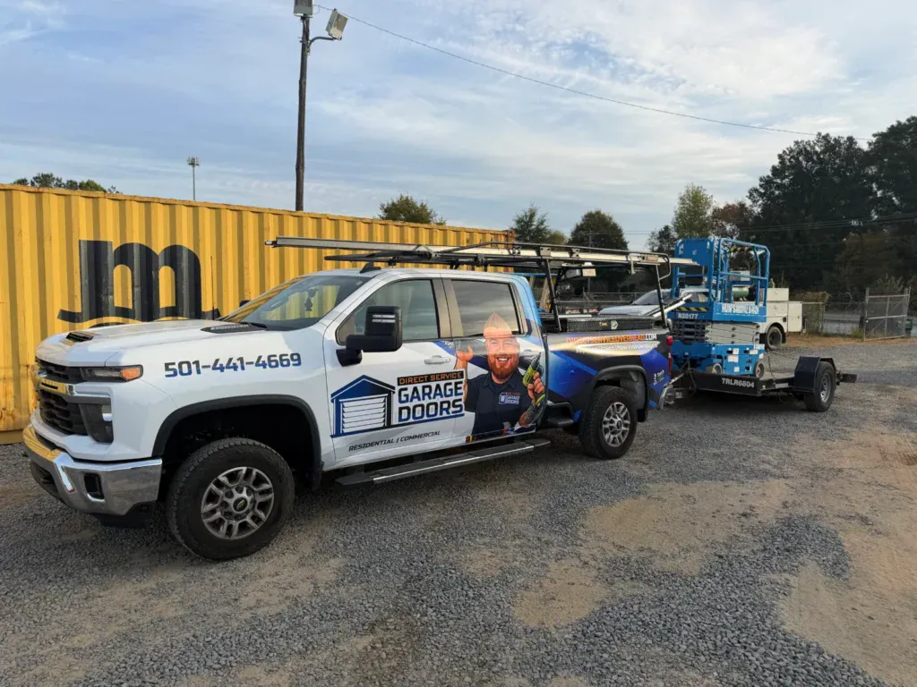 Direct Service Garage Doors service truck towing a scissor lift for commercial garage door work in Central Arkansas