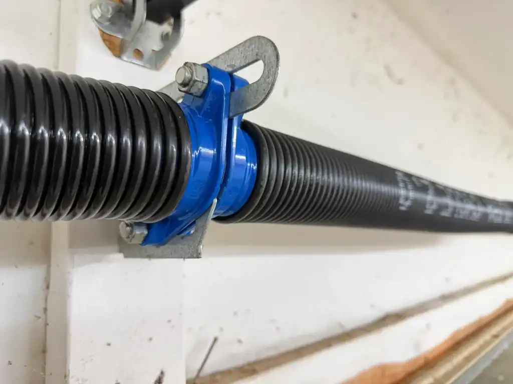 Ultra-Cycle torsion springs on a blue center bracket, installed by Direct Service in Little Rock AR